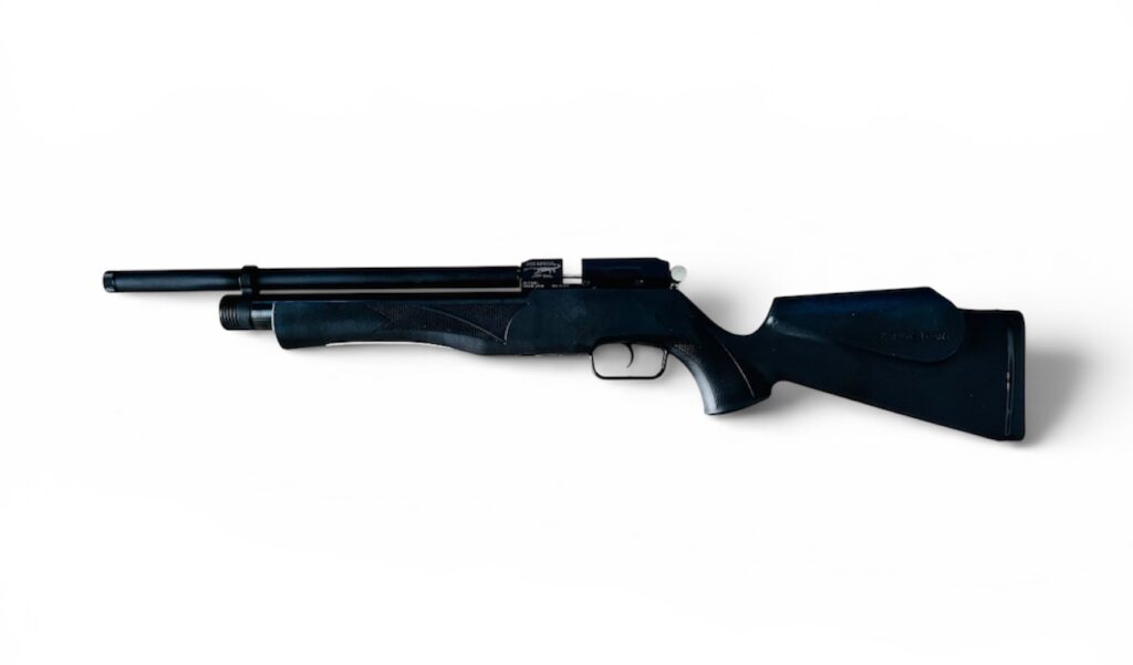 Black hunting rifle laid horizontally on a white background, showing the stock and barrel viewable from the side