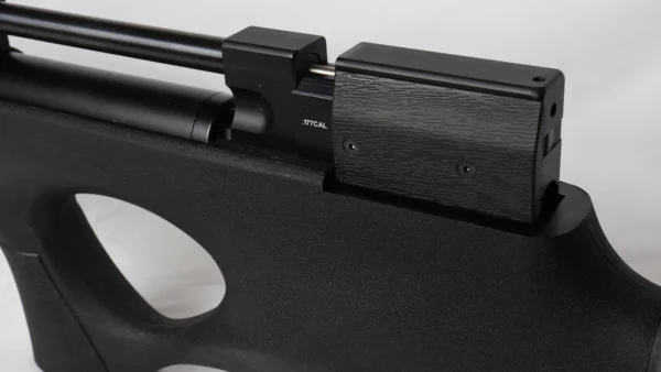 Close-up of a black air rifle showing the receiver mounted on a textured stock, with a small ".177 CAL" marking visible on the breech area.